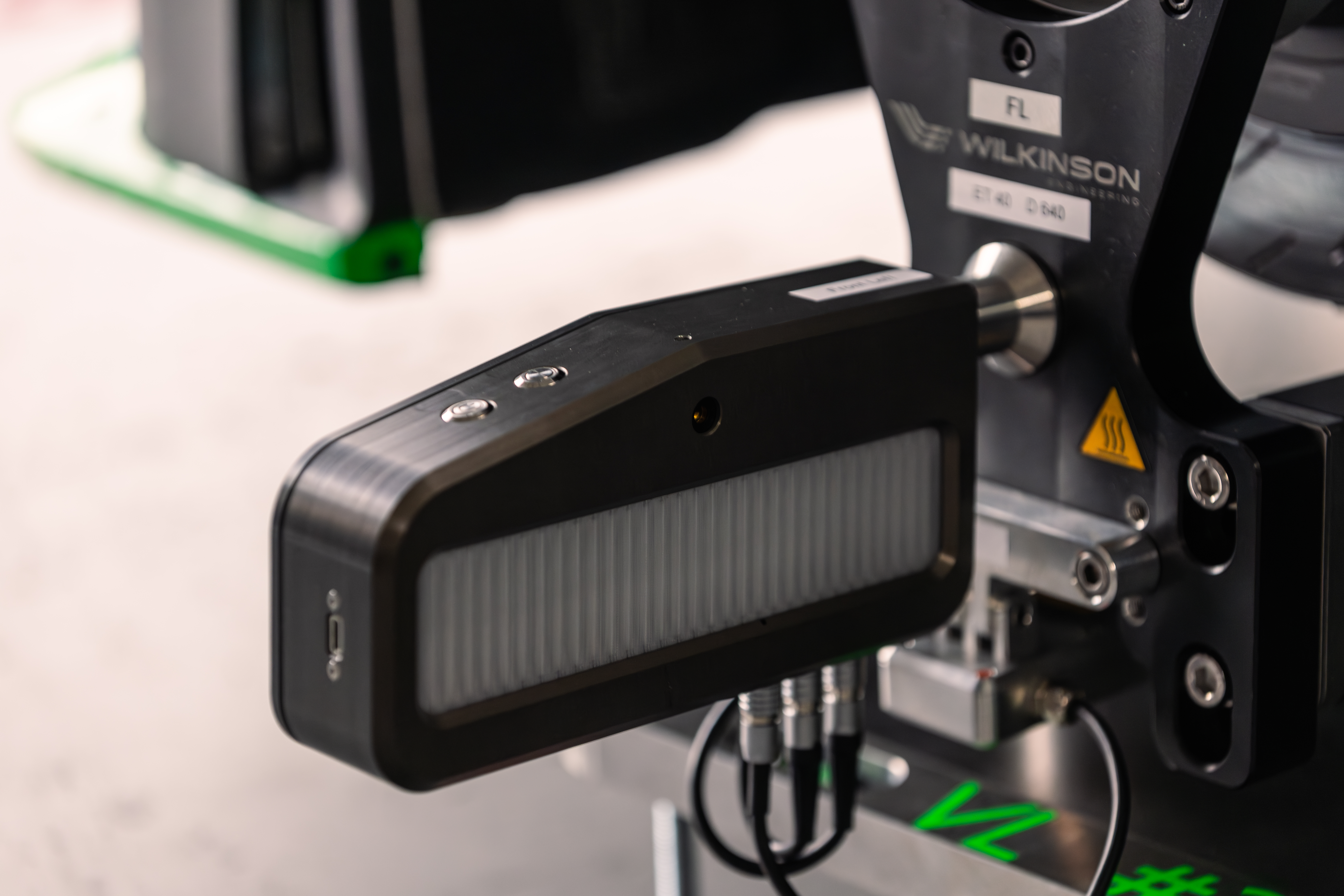 Very close up detail of Trackside Aligner measurement head on Porsche Cayman � EPS Motorsport